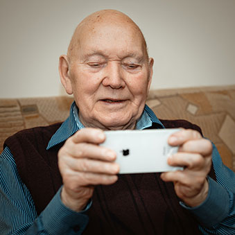 an elderly man using a smartphone